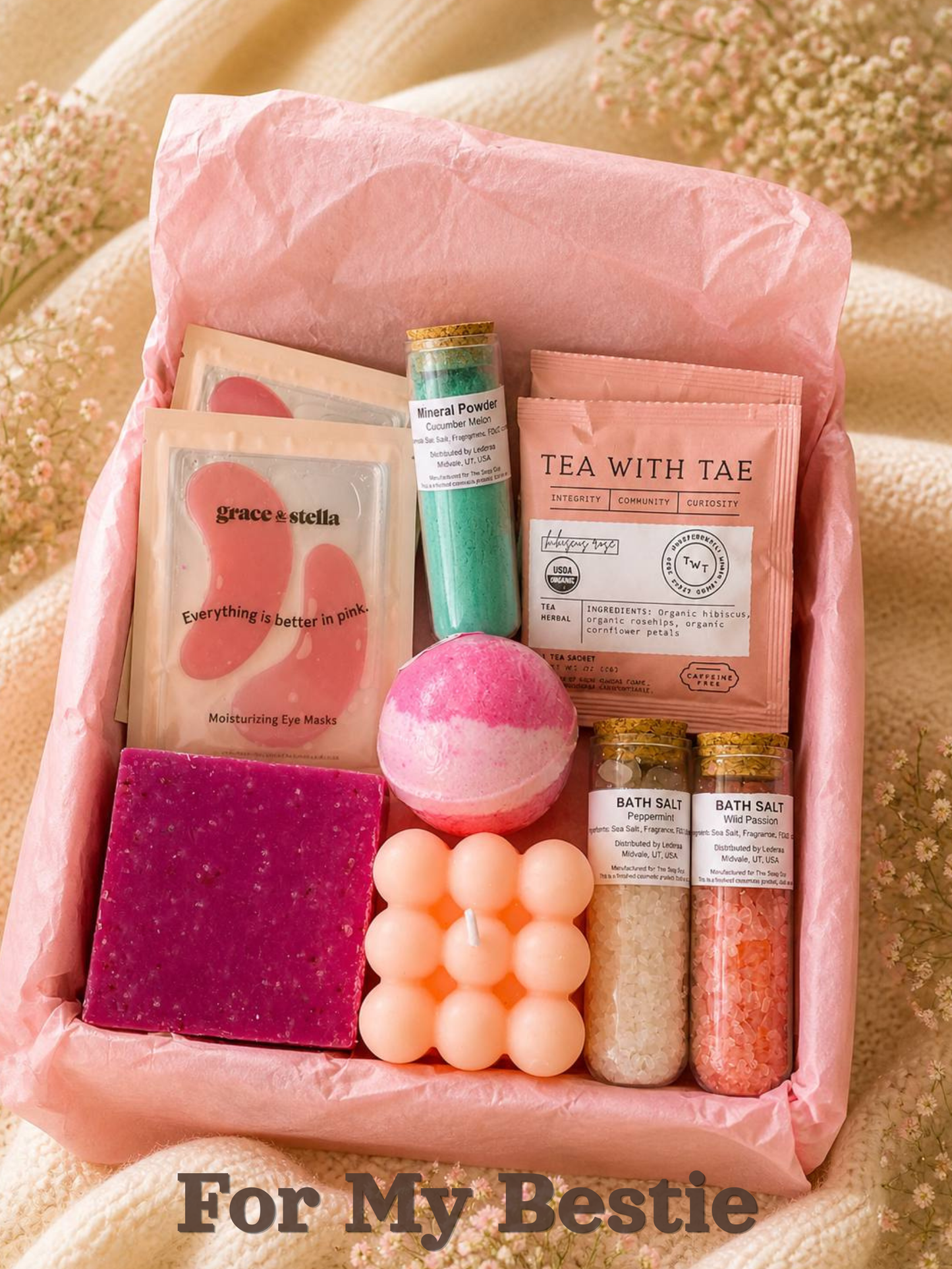 Gift set with bath products including soap, bath bombs, and bath salts on a pink cushion by Lederea