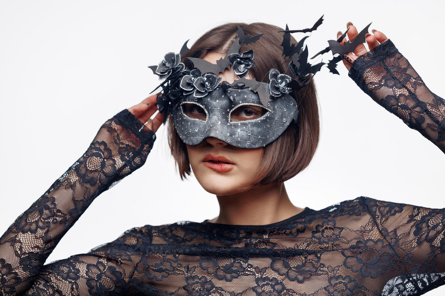 Black masquerade mask for woman with flying bat and flowers, rhinestones, textured finish.