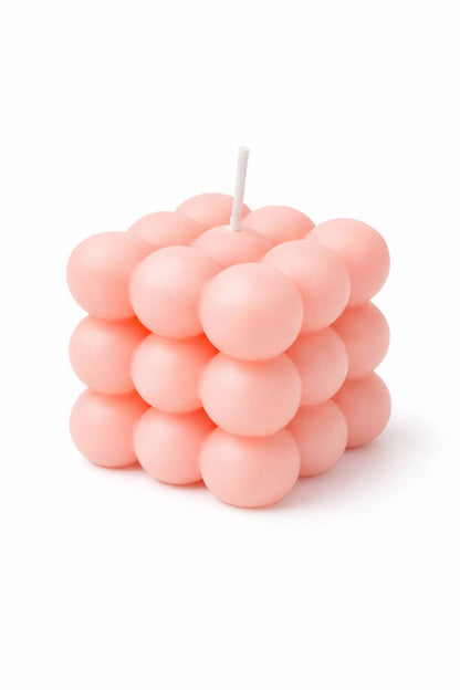 Small pastel pink bubble cube candle held in hand on white background, affordable aesthetic gift under $10