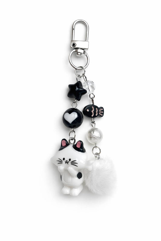 Cute cat keychain with pom pom and charms. Lightweight kawaii accessory for keys, bag or backpack. Affordable cute gift.