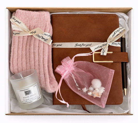Gift set with pink socks, candle, brown leather notebook, and decorative bag in a gift box by Lederea US
