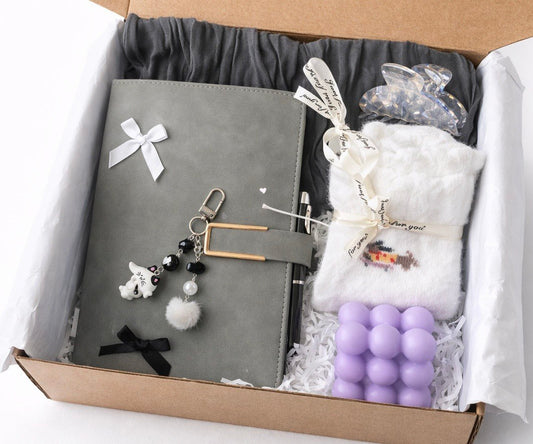 Self care Gift box with a cozy socks gray notebook, keychain, plush toy, and purple candle by Lederea
