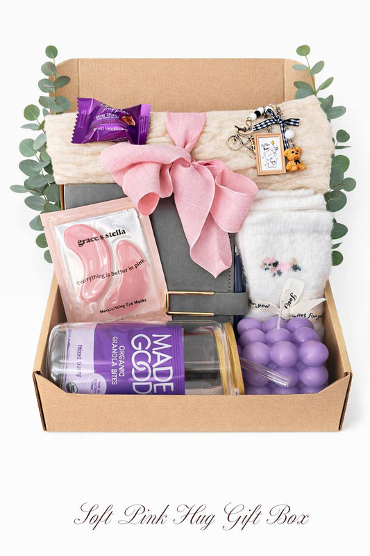 Gift box with various items including a bottle, and purple candle by Lederea US